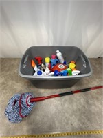 Assortment of household cleaning supplies and mop