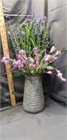Galvanized watering pitcher and flowers