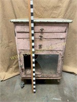 Antique pink rolling side table with metal top