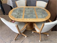 Round /oval oak dining table & 4 rolling chairs