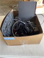 Box with computer keyboard, headphones, speaker,