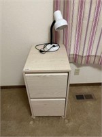 White washed wooden file cabinet and lamp