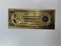 Reproduced note layered in 24k gold
