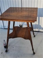 1800s  oak parlor table with brass claw and ball