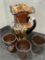 Carnival glass pitcher and cups