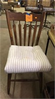 Wood chair with pillow.