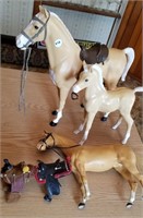 Plastic horse figurines & saddles