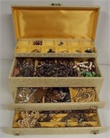 Hinged top two drawer jewelry box filled with