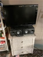 32" Toshiba TV, speakers, and wicker table