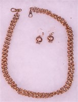 A double strand gold necklace and a pair of
