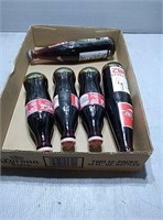 Flat with 5 full coke bottles