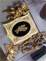 Cherub wall, plaques, and gold candle holder