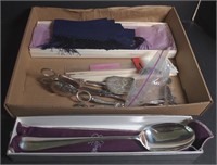 (G) Silver serving utensils and silk scarf