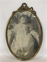 Antique baby photo in oval brass frame