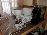 Shelf of kitchenware (George formans, crock pots)