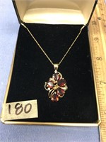A "brown" garnet and diamond pendent set in gold,