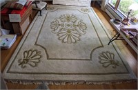(G) 12'x9' cream rug with ornate design and tassel