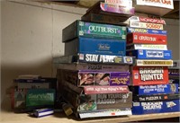 Large lot of board games on top shelf
