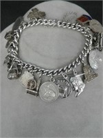 Gold filled charm bracelet with 18 silver charms