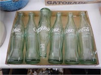 6 Coca Cola Bottles