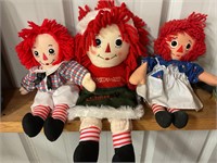 Two raggedy Andy dolls and one Raggedy Ann