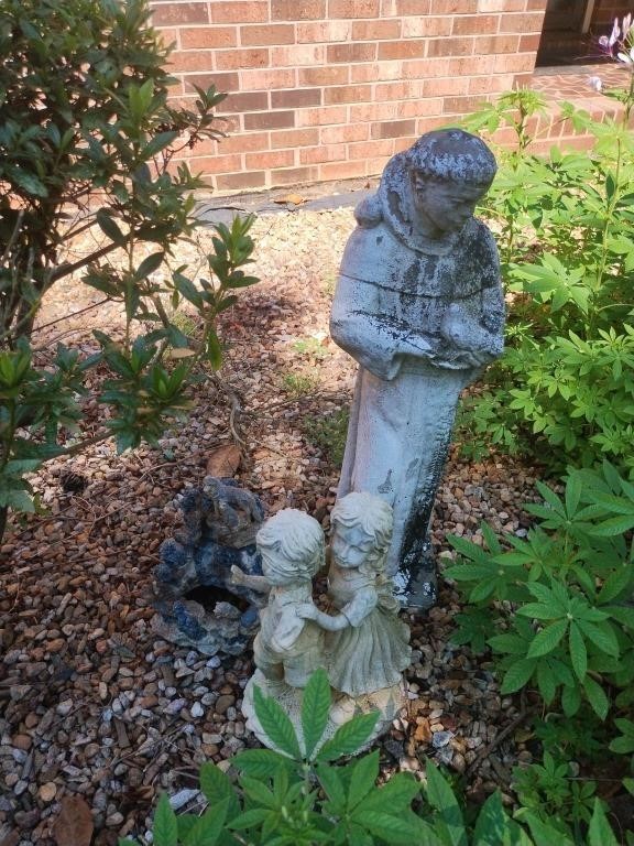 Yard decor including children, friar and a small