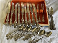 Mismatched silverware in a box