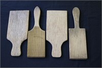 Four old wooden butter paddles two have grooves