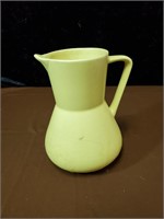 Yellow brush pottery pitcher approx 8 inches tall