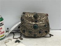 Women’s small metal purse with rock attachments