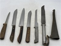 Assortment of knives and a knife sheath