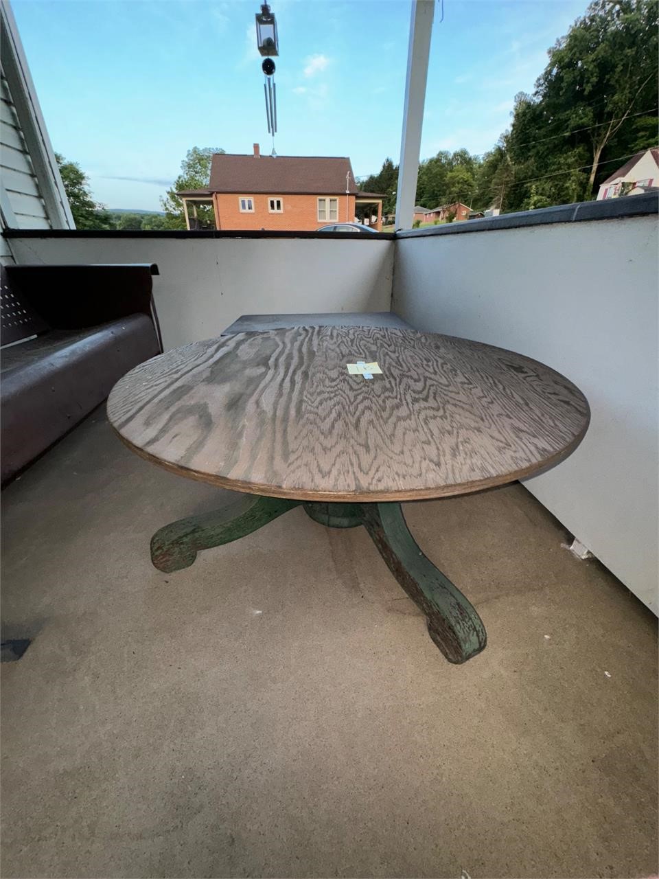 Round outdoor wooden table .