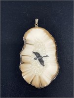 Walrus ivory, intricately scrimmed pendant.