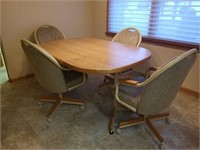Kitchen table with upholstered chairs on rollers