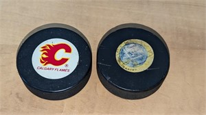 2 Calgary & Buffalo Official Hockey Pucks in Case