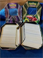 2 tins of pokemon cards