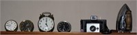 contents of shelf - clocks, camera, iron