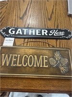 Signs “ gather here” and “welcome”