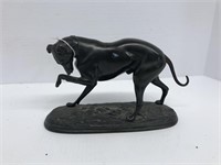 Bronze dog with bandage for foot