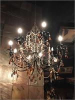 Metal base chandelier with beads and prisms.