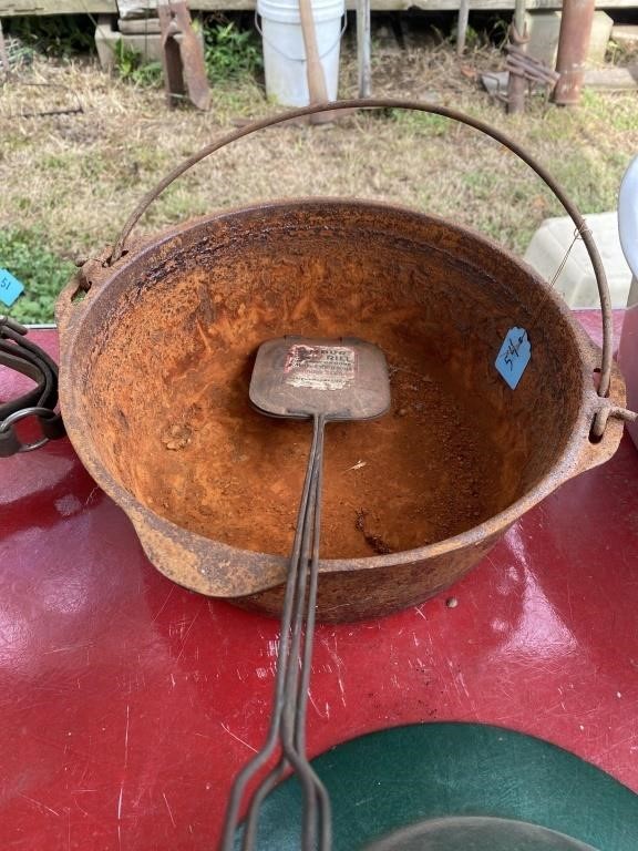 Rusted Dutch oven with no lid and camp hamburger