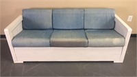 White wooden sofa with blue cushions