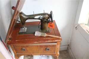 New home sewing machine in cabinet