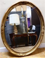 Oval gold frame hanging mirror