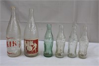 Collection of bottles 4 Coke and 2 Kik Cola