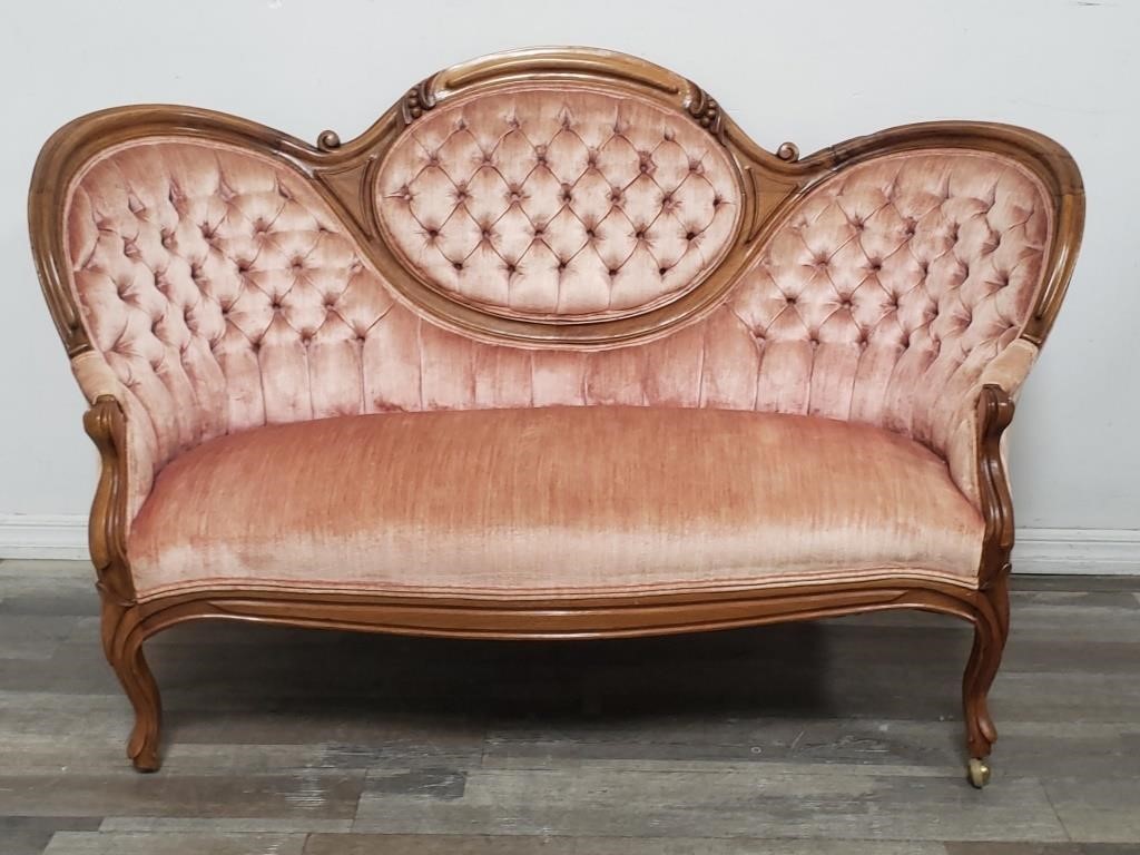 Victorian-style carved wood upholstered love seat