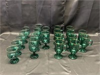 21 pieces of green stemware with gold rim