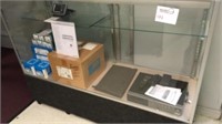 Glass display case on wheels and contents