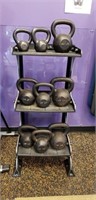 Lot of nine kettlebells and stand