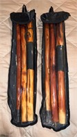 2 wooden walking sticks in bags